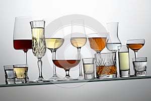 Alcoholic drinks on a tilted glass shelf