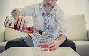 Alcoholic drunk Business man in loose time on couch drinking whisky