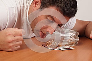 Alcoholic licking his spilt drink