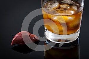 Alcoholic liver damage and cirrhosis concept with a liver next to a glass of alcohol. Cirrhosis is most commonly caused by