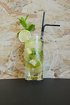 An alcoholic mojito drink served in a tall glass