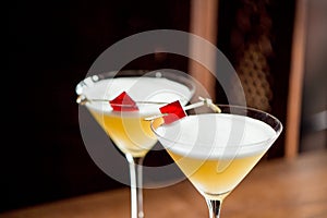 Alcoholic yellow cocktails in martini glasses