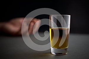 Alcoholism and alcohol abuse glass of whiskey or cognac or alcohol drink