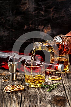 Alcoholism, alcohol addiction and people concept - male alcoholic with bottle and glass drinking whiskey at night.Businessman