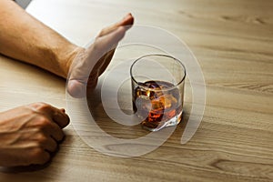 Alcoholism concept . Hands lock chain a glass of whiskey