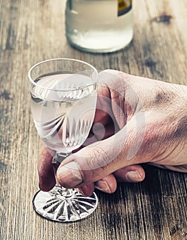 Alcoholism. Man hand alcoholic and drink the distillate photo