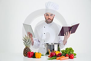 ?ale chef cook holding table computer and recipe book