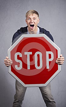 Alert man showing stop sign. photo