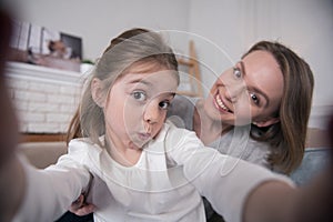 Alert mummy and daughter taking selfies