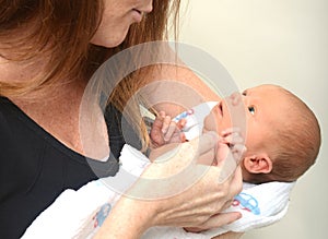 Alert newborn looking up at mom