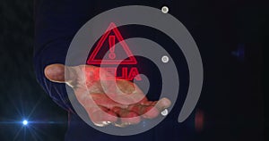 Alert warning symbol over hand