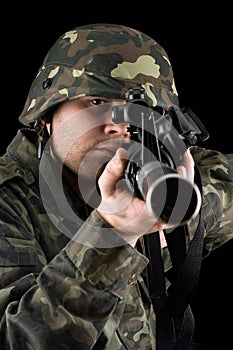 Alerted soldier pointing m16 in studio