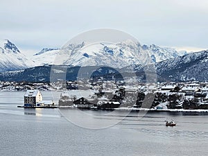 Alesund Norway seaport with mountains and old storehouses