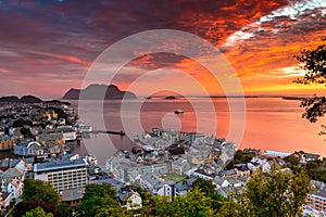 City Seascape with Aerial View of Alesund Center, Islands and Atlantic Ocean at Gorgeous Sunset photo