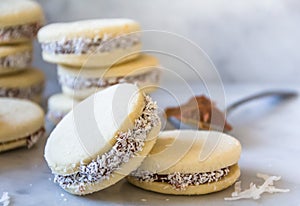 `Alfajores` delicious traditional Argentine sandwich cookies filled with caramelized milk - `dolce de leche`, and shredded coconut