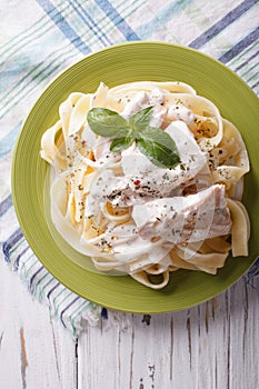Alfredo pasta in cream sauce with chicken closeup. vertical top