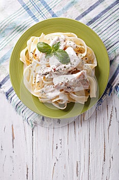 Alfredo pasta in cream sauce with chicken. vertical top view