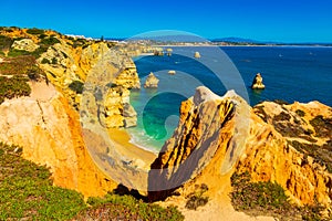 Algarve, Portugal: Wonderful blue ocean lagoon and sandy beach among yellow cliffs. Place is located by the Atlantic