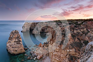 Algarve summer vacations destinations in Portugal. Marinha Beach at sunset