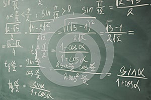 Algebra, mathematics. Trigonometry and elementary functions written on the chalkboard. photo