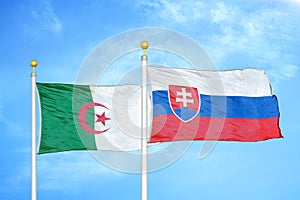 Algeria and Slovakia two flags on flagpoles and blue sky