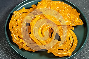 Algeria sweet food named zlabi, in Inde named Jalebi, it is prepared with flour and yogurt and honey and other ingredients