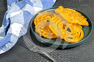 Algeria sweet food named zlabi, in Inde named Jalebi, it is prepared with flour and yogurt and honey and other ingredients