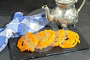 Algeria sweet food named zlabi, in Inde named Jalebi, it is prepared with flour and yogurt and honey and other ingredients photo