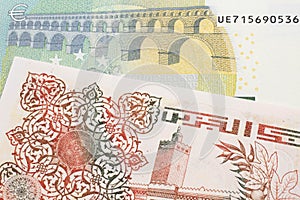 An Algerian dinar with a Euro note