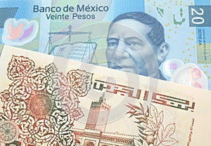 An Algerian dinar with a Mexican peso note