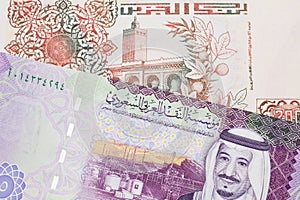 An Algerian dinar with a Saudi riyal note