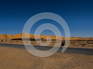 Algerian Sahara desert oasis of Thaghit Bechar  Sand dunes behind the road