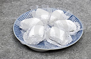 algerian traditional cookies named makrout is a almond paste forming diamond shape and covered with icing sugar.