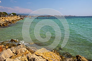 Alghero, Sardinia, Italy - Summer skyline view of the rocky Alghero coast and beach at the Gulf of Alghero at Mediterranean Sea