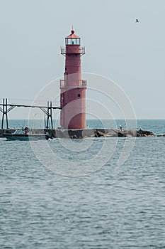 Algoma Pierhead Lighthouse - Lake Michigan, in Wisconsin, as a boat passes by