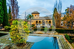 Alhambra de Granada. El Partal. A large central pond faces the arched portico behind which stands the Tower of the