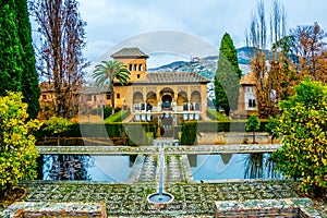 Alhambra de Granada. El Partal. A large central pond faces the arched portico behind which stands the Tower of the