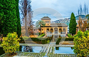 Alhambra de Granada. El Partal. A large central pond faces the arched portico behind which stands the Tower of the