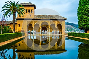 Alhambra de Granada. El Partal. A large central pond faces the arched portico behind which stands the Tower of the