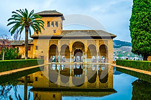 Alhambra de Granada. El Partal. A large central pond faces the arched portico behind which stands the Tower of the