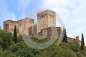 View at the Alhambra citadel towers fortress, from Paseo de los Tristes, walk of the sad The Promenade of the Sad, Granada, photo