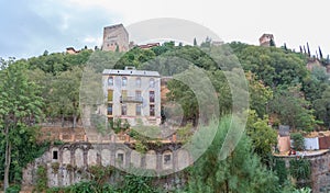 View at the Alhambra citadel on top, from Paseo de los Tristes, walk of the sad The Promenade of the Sad, classic buildings and photo