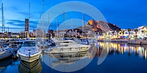 Alicante Port d`Alacant marina with boats and view of castle Castillo twilight travel traveling holidays vacation panorama in photo