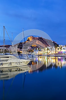 Alicante Port d`Alacant marina with boats and view of castle Castillo twilight travel traveling holidays vacation portrait format photo
