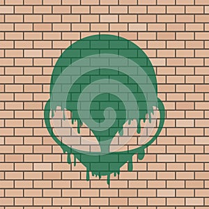 Alien face illustration in brick wall