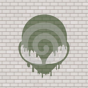 Alien face illustration in brick wall