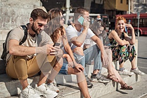 Group of friends using smartphones. Emotional isolation and technology depresion photo