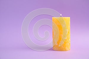 Alight wax candle on color background