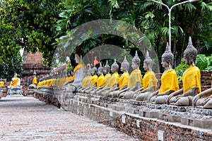 Aligned Buddha statues at Wat Yai Chaimongkol, Ayutthaya, Thailand.