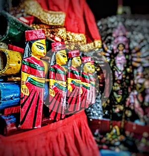 Aligned Clay Dolls with Idol of Goddess Durga in Background.